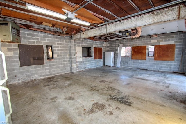 garage featuring a garage door opener and white refrigerator