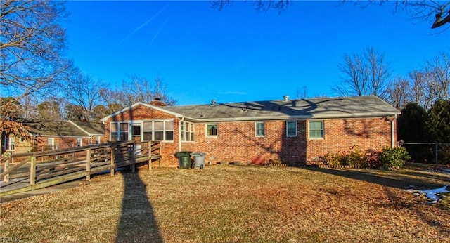 back of house with a lawn