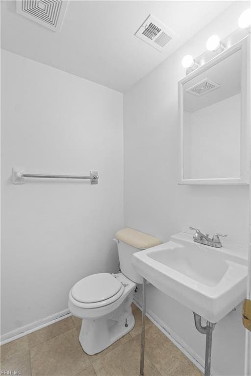 bathroom featuring toilet and tile patterned flooring