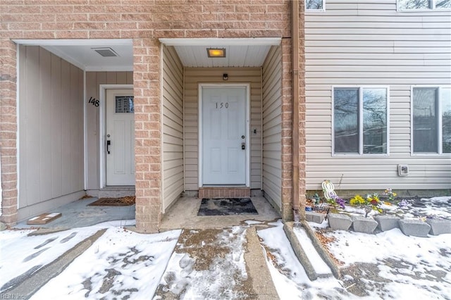 view of snow covered property entrance