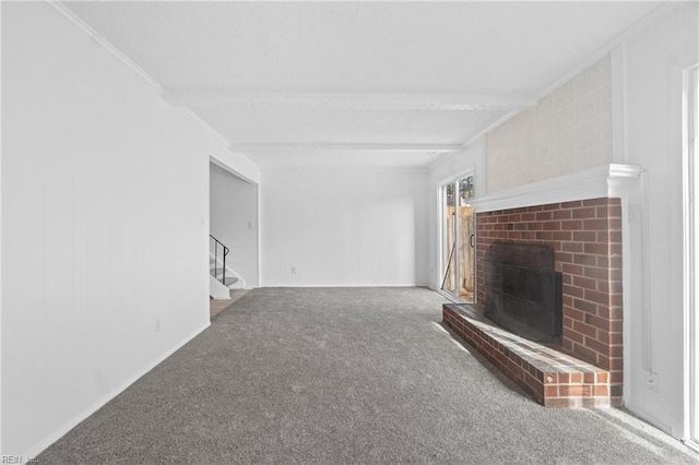 unfurnished living room featuring a brick fireplace, beamed ceiling, and carpet flooring