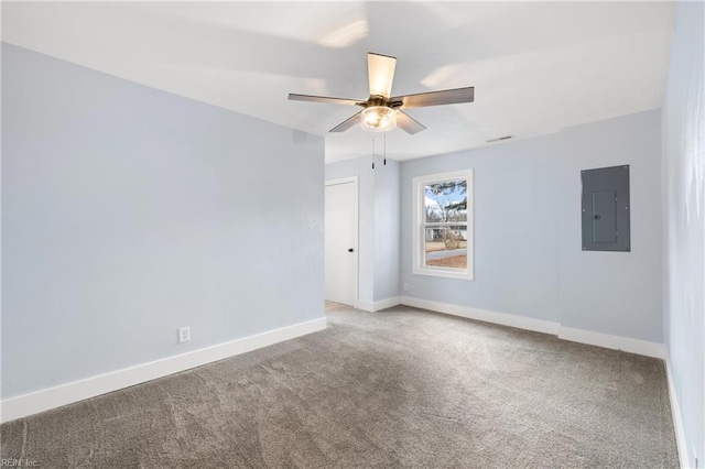 carpeted empty room with ceiling fan and electric panel