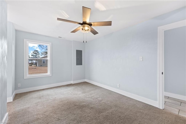 carpeted spare room featuring ceiling fan and electric panel