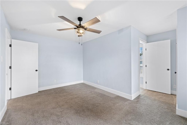 unfurnished room with light colored carpet and ceiling fan