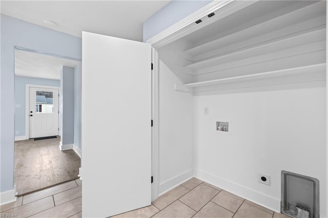 laundry room featuring electric dryer hookup, light tile patterned floors, and hookup for a washing machine