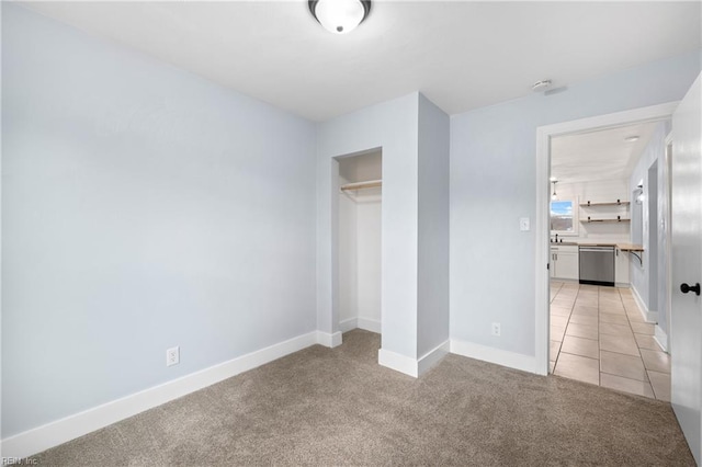 unfurnished bedroom with light tile patterned flooring and a closet