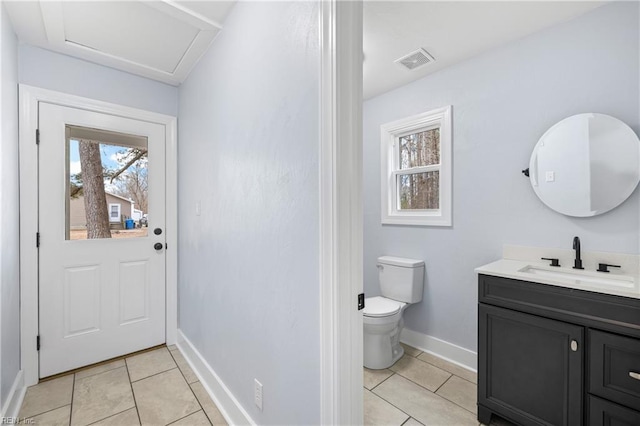 bathroom featuring vanity, tile patterned floors, and toilet