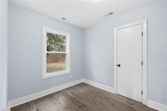 empty room with wood-type flooring