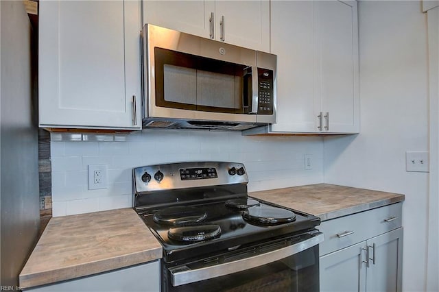 kitchen featuring stainless steel appliances, tasteful backsplash, and white cabinetry