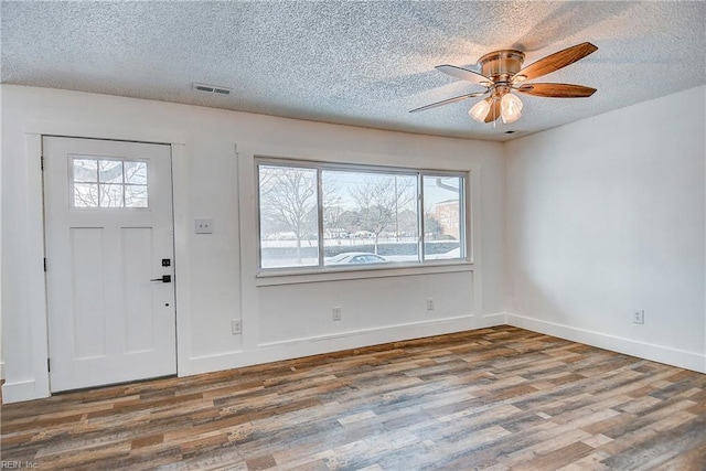 entrance foyer with hardwood / wood-style flooring, a textured ceiling, and a wealth of natural light