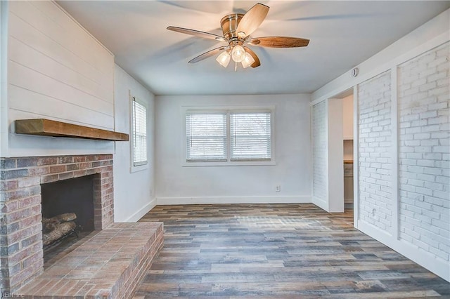 unfurnished living room with ceiling fan, a fireplace, and dark hardwood / wood-style flooring