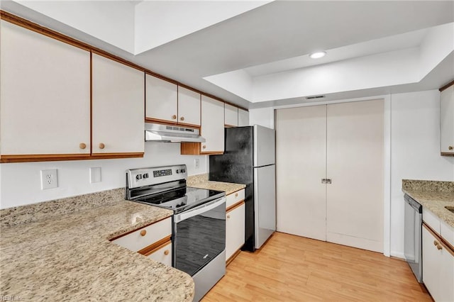 kitchen featuring white cabinetry, light stone countertops, stainless steel appliances, and light hardwood / wood-style floors