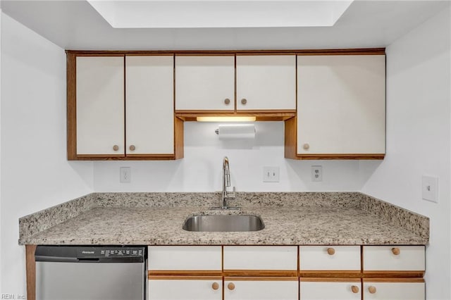 kitchen with white cabinetry, dishwasher, sink, and light stone countertops