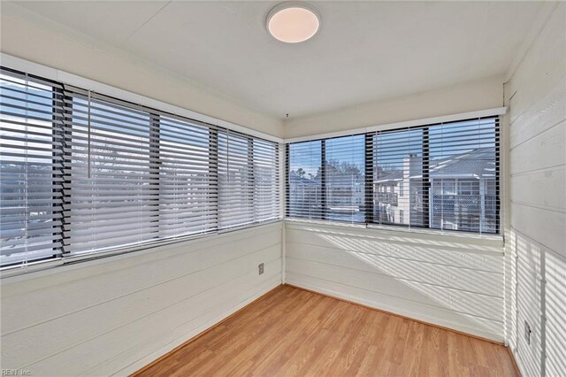 spare room with hardwood / wood-style flooring and a wealth of natural light