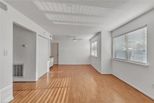 spare room with light hardwood / wood-style floors and ceiling fan