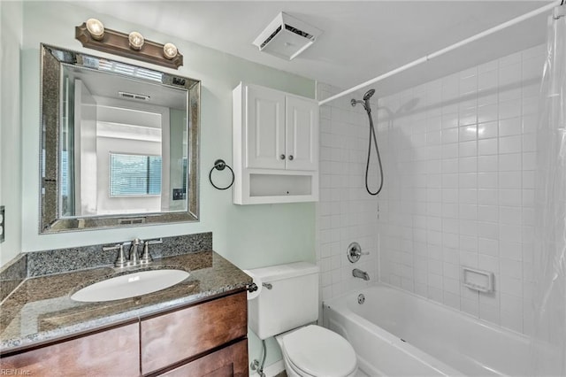 full bathroom featuring vanity, toilet, and tiled shower / bath