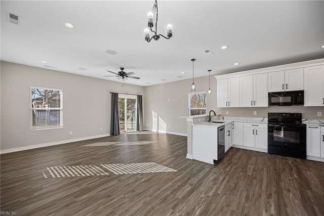 kitchen with sink, black appliances, white cabinets, dark hardwood / wood-style flooring, and decorative light fixtures