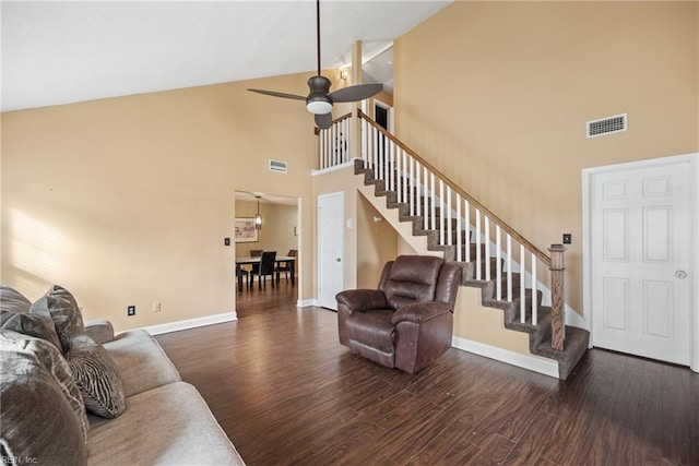 living room featuring ceiling fan, dark hardwood / wood-style flooring, and high vaulted ceiling