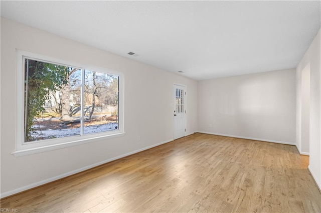 unfurnished room with light hardwood / wood-style floors