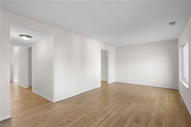 unfurnished room with light wood-type flooring