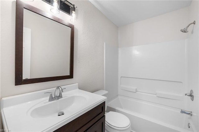 full bathroom featuring vanity, bathtub / shower combination, and toilet