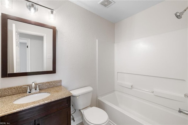 full bathroom featuring vanity, bathing tub / shower combination, and toilet