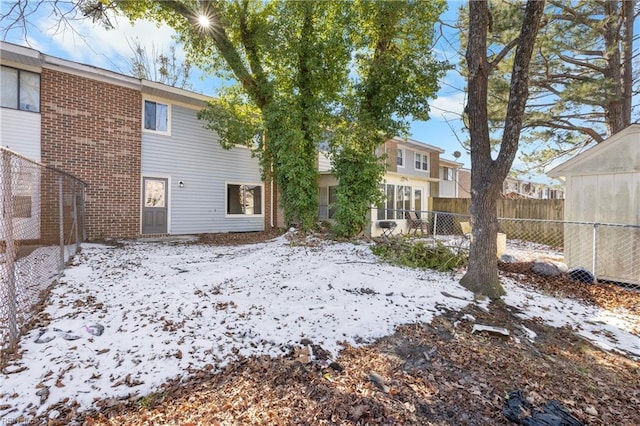 view of snow covered rear of property