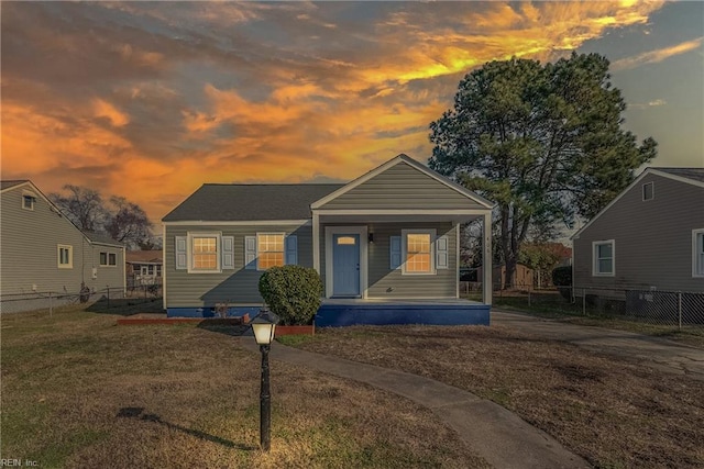 bungalow featuring a yard and covered porch