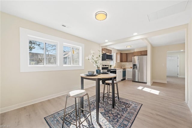 dining room with light wood-type flooring