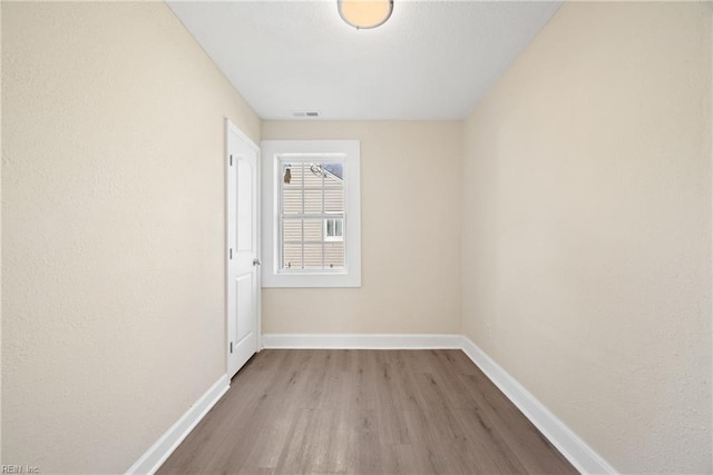 spare room with light hardwood / wood-style floors