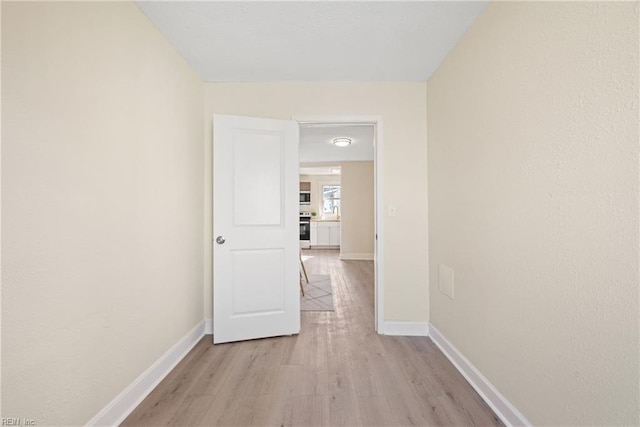 corridor featuring light wood-type flooring