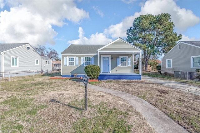 bungalow-style home with a front yard and covered porch