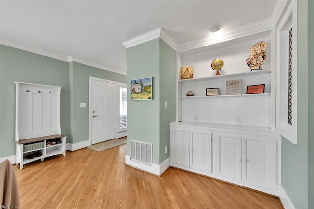 foyer featuring crown molding and light hardwood / wood-style floors