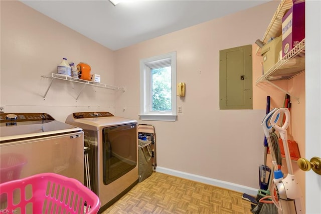 laundry room with light parquet floors, electric panel, and washer and clothes dryer