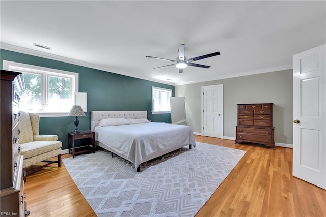 bedroom featuring ornamental molding, hardwood / wood-style floors, and ceiling fan