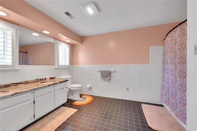 bathroom featuring tile walls, tile patterned flooring, vanity, a shower with curtain, and toilet