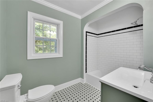 full bathroom featuring crown molding, vanity, toilet, and tiled shower / bath combo