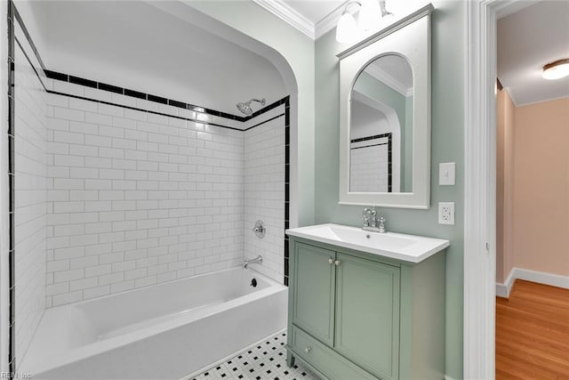 bathroom with vanity, crown molding, tile patterned floors, and tiled shower / bath