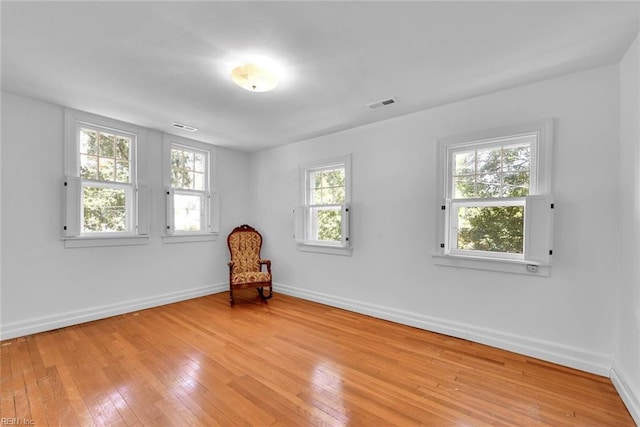 sitting room featuring a healthy amount of sunlight and light hardwood / wood-style flooring