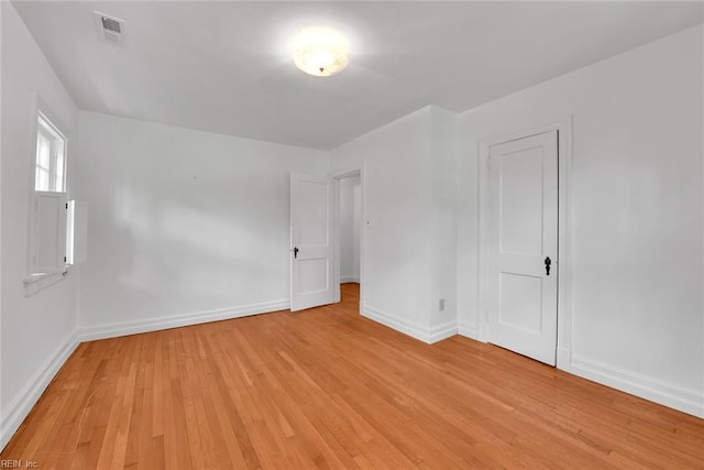 empty room with light hardwood / wood-style flooring