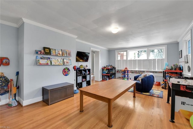 rec room with light hardwood / wood-style flooring and ornamental molding