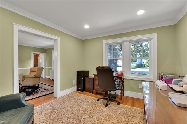 office area with crown molding and light hardwood / wood-style flooring