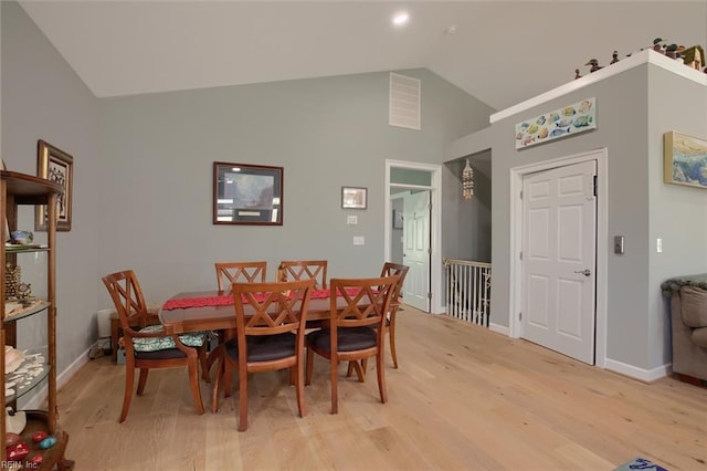 dining area with lofted ceiling and light hardwood / wood-style floors