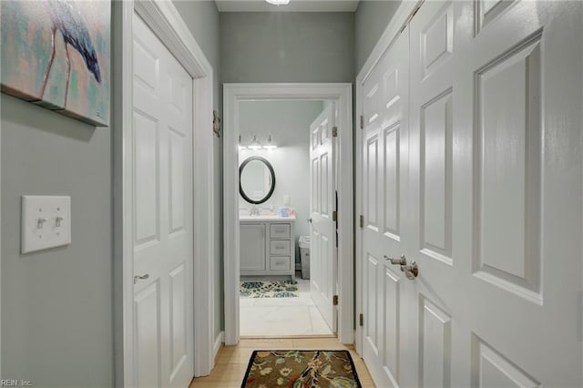 hallway featuring sink and light wood-type flooring