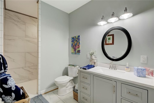 bathroom featuring tiled shower, vanity, toilet, and tile patterned floors