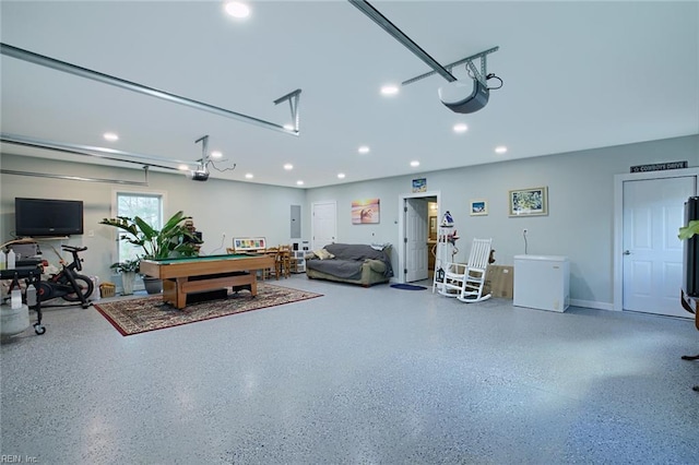 garage with fridge, a garage door opener, and electric panel