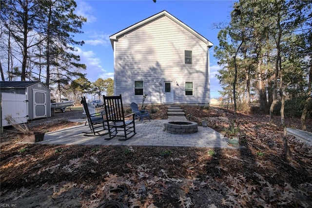 back of house with a patio, a shed, and an outdoor fire pit