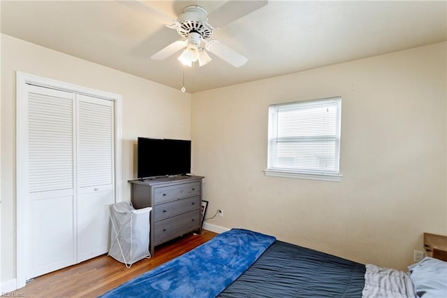 bedroom featuring hardwood / wood-style floors, a closet, and ceiling fan