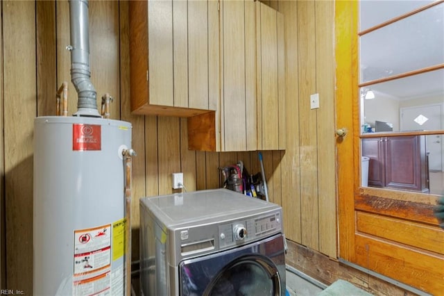 utilities featuring water heater and washer / dryer