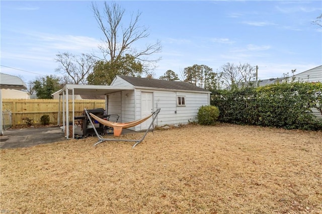 exterior space with a carport and an outdoor structure